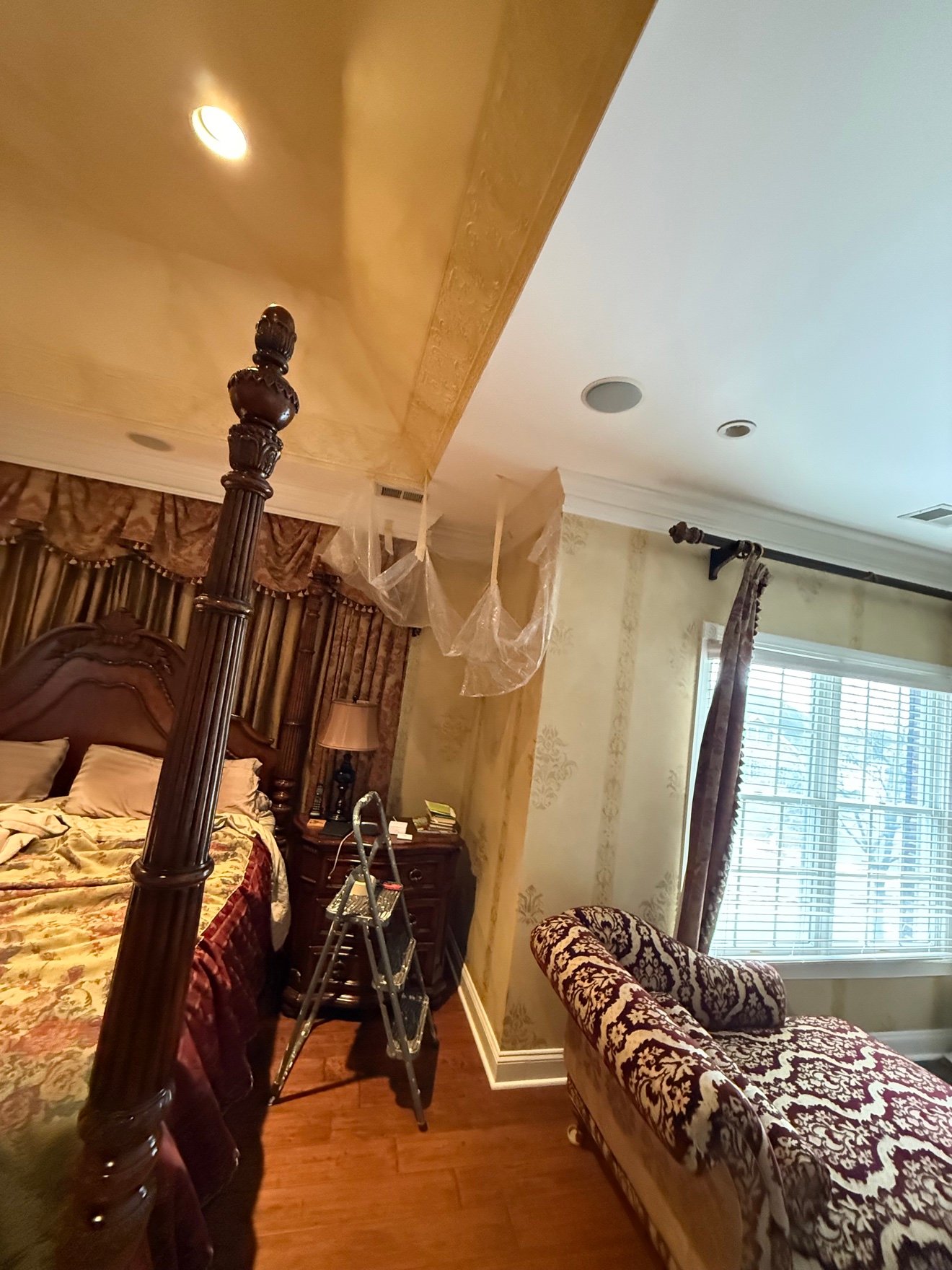 Bedroom ceiling water damage — protection sheeting before repair