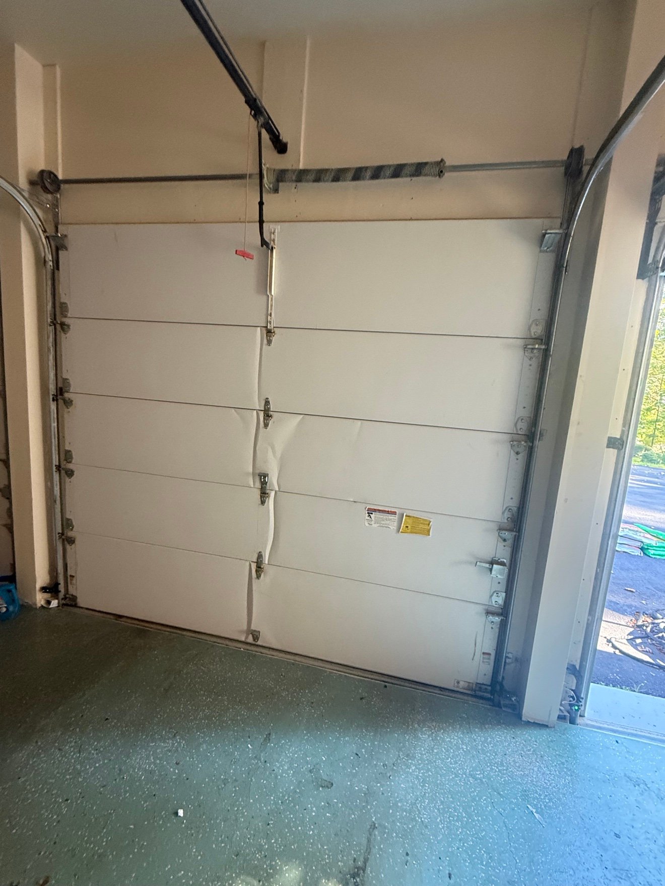 Dented garage door panels before repair