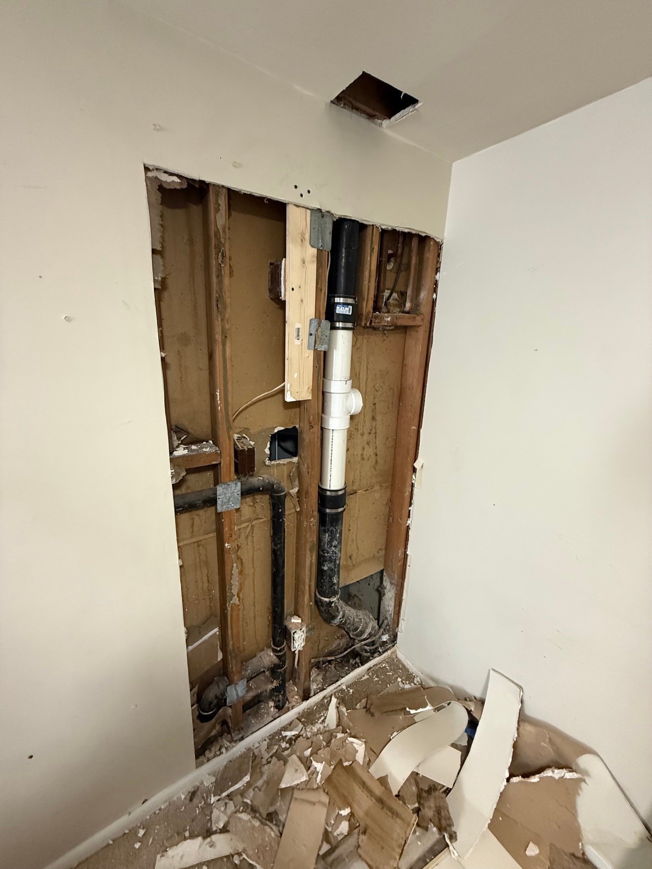 Drain stack exposed in opened wall
